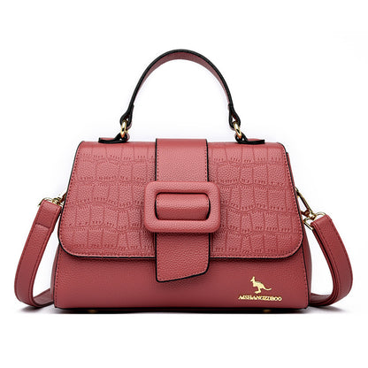 Pink textured handbag with a kangaroo logo on a white background
